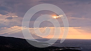 Divine light, stormy sky and sunrise on a landscape around holy mountain Athos