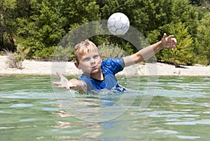 Diving for a ball in a lake