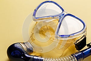 Diving equipment. Snorkeling mask and tube on yellow background. Colorful background. Top view. Copy space