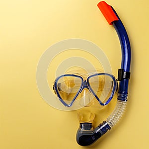 Diving equipment. Snorkeling mask and tube on yellow background. Colorful background. Top view. Copy space