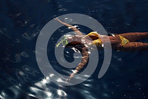 Diving girl in the sea surface