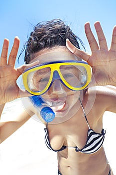 Diving girl in a swimming mask and snorkel