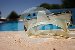 Diving glasses on poolside