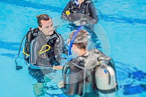 Diving instructor and students. Instructor teaches students to dive