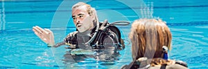 Diving instructor and students. Instructor teaches students to dive BANNER, long format