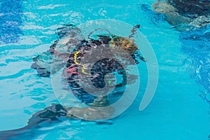 Diving instructor and students. Instructor teaches students to dive
