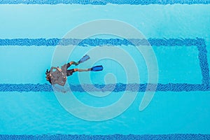 Diving instructor and students. Instructor teaches students to dive