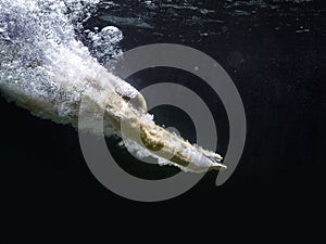 Diving man in a black pool
