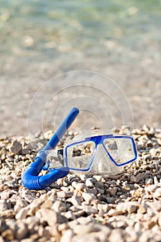 Diving mask and pipe at summer beach