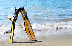 Diving mask, snorkel and fins on a beach
