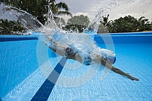 Diving into swimming pool photo