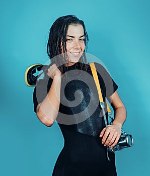 Diving and underwater video shooting. Sexy woman with underwater camera equipment. Sensual underwater diver with wet
