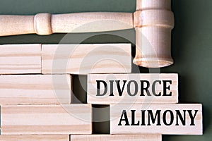 DIVORCE ALIMONY - words on wooden blocks on a white background with a judge\'s gavel