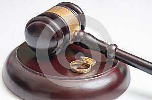 Divorce concept. Wooden gavel and golden rings