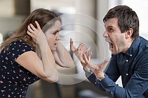 Divorce concept. Young angry couple arguing and shouting.