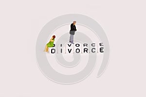 Divorce concept with young couple miniature close to separation