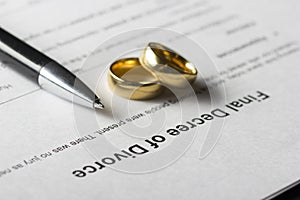 Divorce decree form with marriage ring and pen