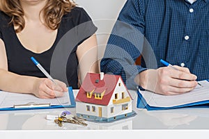 Divorce and dividing a property concept. Man and woman are signing divorce agreement