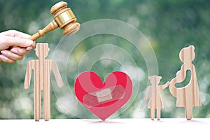 Divorce lawyer Or Attorney, Broken red heart with husband and wife splitting children on natural green background,Joint child