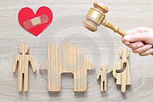 Divorce lawyer Or Attorney, Husband and wife splitting children on wooden background,Joint child custody and alimony concept