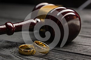 Divorce and separation concept. Two golden wedding rings, judge gavel