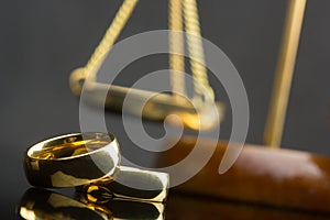 Divorce and separation concept. Two golden wedding rings and judge gavel