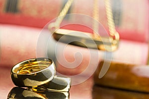 Divorce and separation concept. Two golden wedding rings and judge gavel