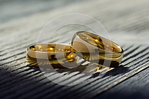 Divorce and separation concept. Two golden wedding rings, judge gavel