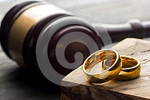 Divorce and separation concept. Two golden wedding rings, judge gavel