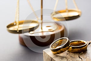 Divorce and separation concept. Two golden wedding rings, judge gavel.