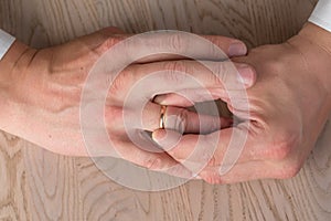 Divorce, separation: man removing wedding or engagement ring, top view