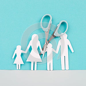 Divored parents, custody battle for the children, scissors cut the family, paper cut out, conflict in relationship, broken marriag