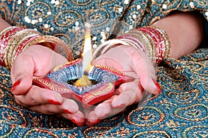 Diwali Celebration Diya Light on a Female Hand