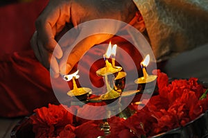 Diwali festival of lights , hand lighting an indian oil lamp