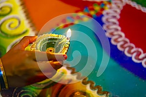 Diwali or festive of lights. Traditional Indian diwali festival, woman hands holding oil lamp