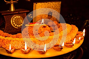 Diwali glowing Diya , flowers, Sweets and Gifts arranged in circular shape forming a design with copy space, selective focus ,