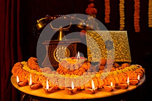 Diwali glowing Diya , flowers, Sweets and Gifts arranged in circular shape forming a design with copy space, selective focus ,