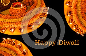 Diwali glowing Diya , flowers, Sweets and Gifts arranged in circular shape forming a design with copy space, selective focus ,