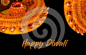 Diwali glowing Diya , flowers, Sweets and Gifts arranged in circular shape forming a design with copy space, selective focus ,