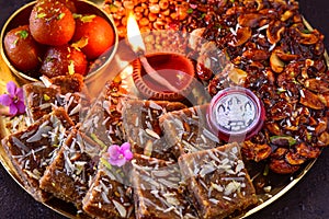 Diwali prasad thaali with earthen lamp diya and silver coin