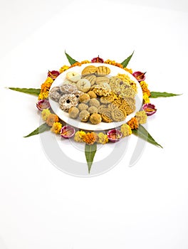 Homemade snacks with flowers kept with rangoli