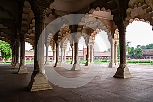 Diwan-I-Am Hall of Audience in Agra Red Fort from inside with ambient light creating soft shadows and overexposed bright sky as