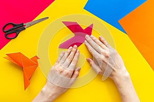 DIY concept. Doing origami paper bird, Top view