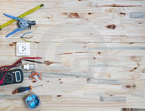 Electrical tools and equipment on wooden background with copy space