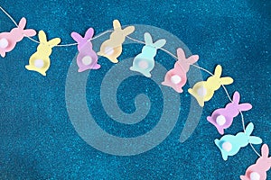 Diy Easter garland bunnies, flags EASTER made paper blue background. Gift idea, decor Spring, Easter