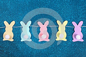 Diy Easter garland bunnies, flags EASTER made paper blue background. Gift idea, decor Spring, Easter