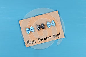 Diy greeting card father day pasta form bow tie blue background. Gift idea, decor Father day, Daddy