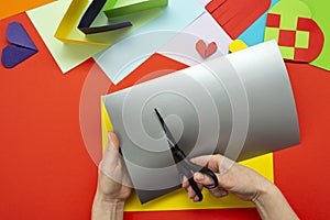 DIY instruction. The process of making a paper heart from yellow and gray colored paper for Valentine\'s Day