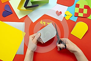 DIY instruction. The process of making a paper heart from yellow and gray colored paper for Valentine\'s Day