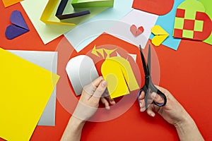 DIY instruction. The process of making a paper heart from yellow and gray colored paper for Valentine\'s Day